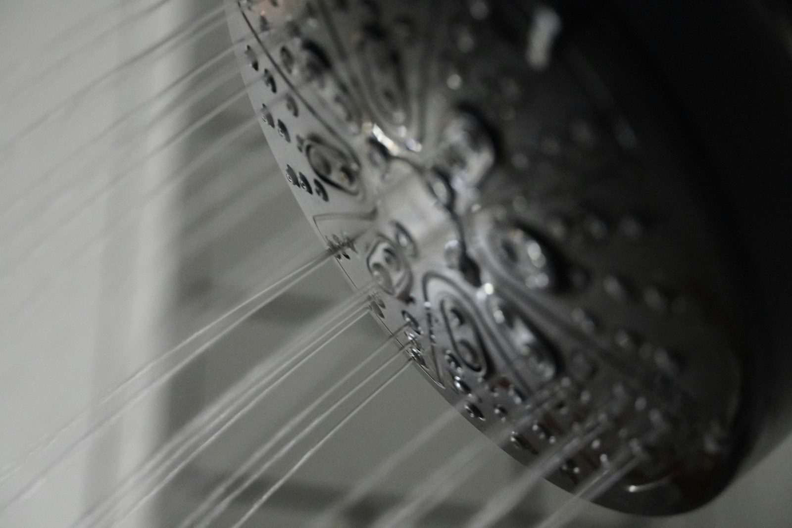 a close up of a shower head in a bathroom